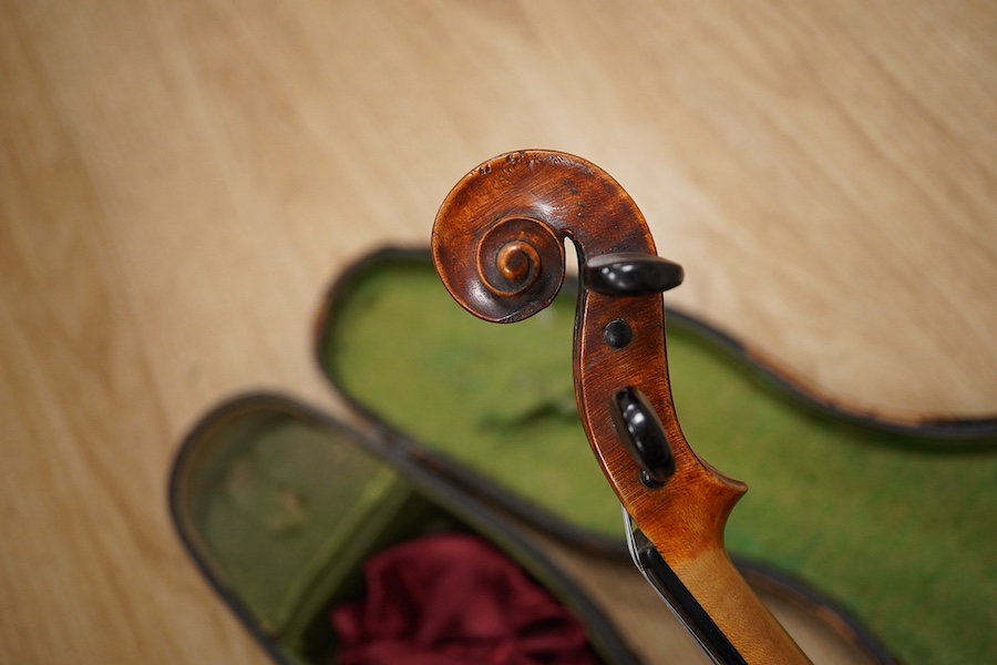 A late 19th century German violin from the Mittenwald region, body length 36cm, in a contemporary case. Condition - fair to good, condition of the case - poor.